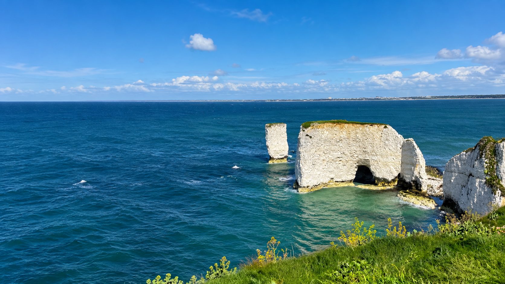 Chalk stacks of different sizes standing together in turquoise shallows.